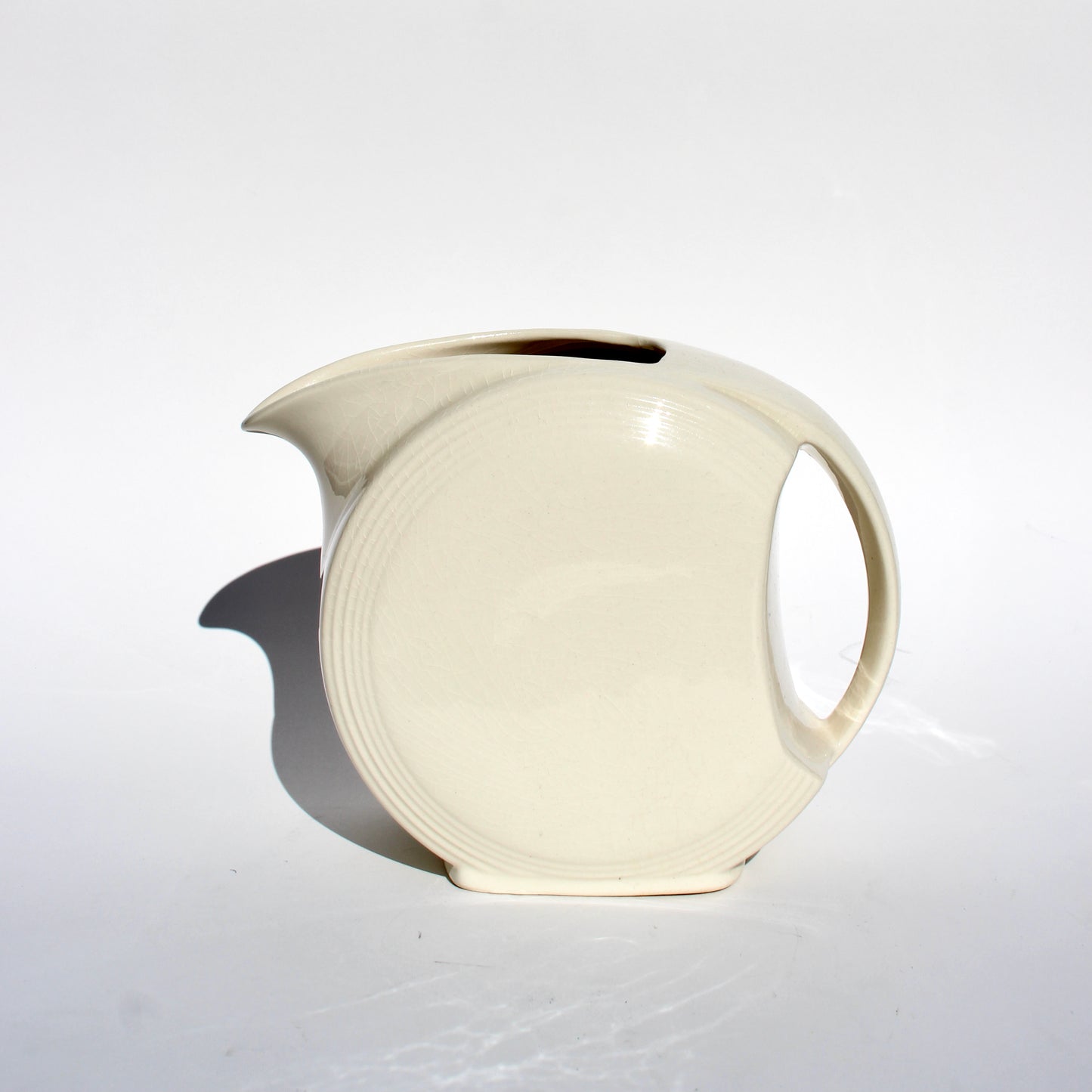 cream ceramic disc pitcher